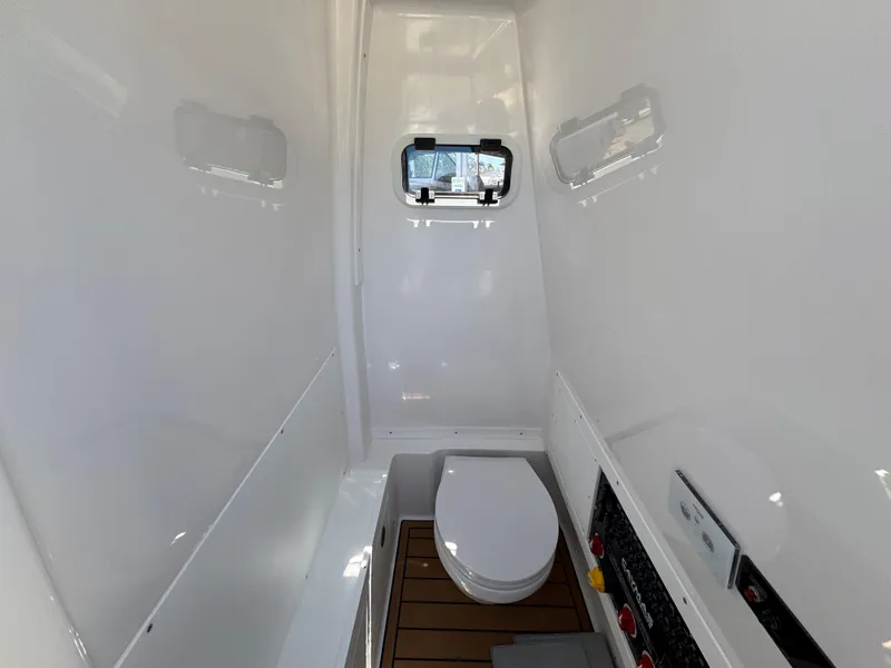 Slide: The Image of 2025 Caymas 291 boat interior with compact bathroom and window. - 29