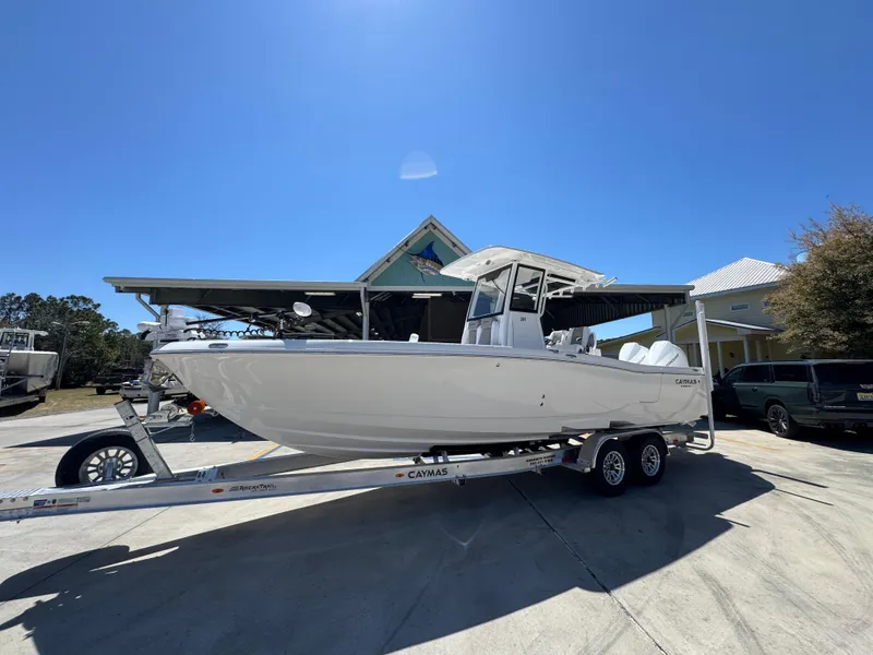 Slide: The Image of 2025 Caymas 291 boat on trailer under clear blue sky. - 3