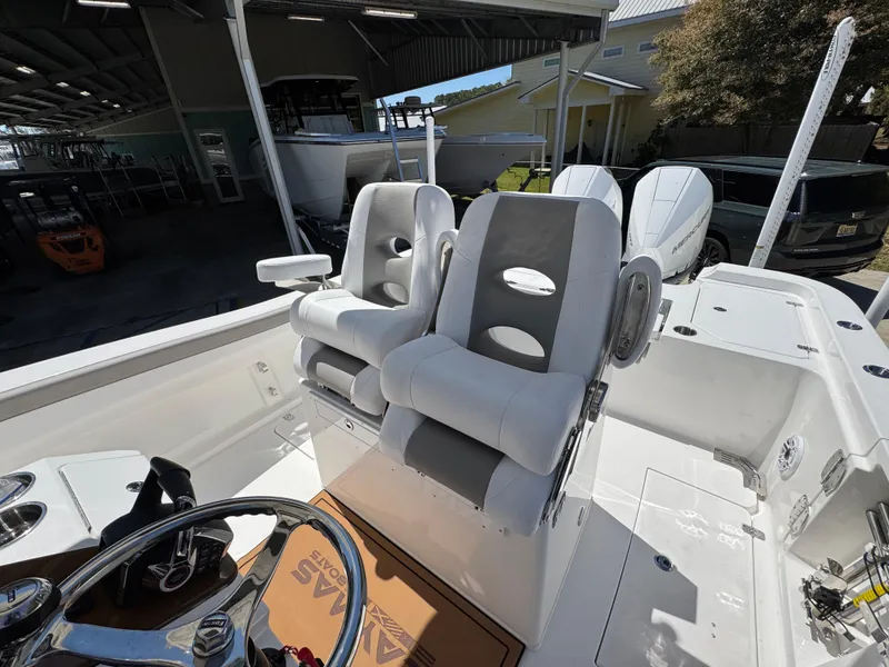 Slide: The Image of 2025 Caymas 291 boat interior with dual captain's chairs and steering wheel. - 30