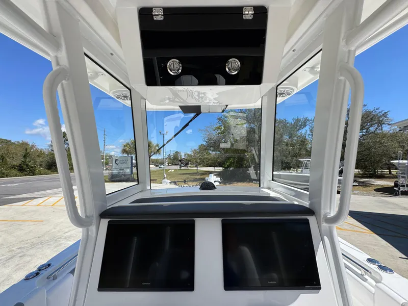 Slide: The Image of 2025 Caymas 291 boat cockpit with dual screens and modern design. - 34