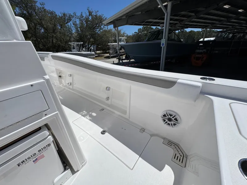 Slide: The Image of 2025 Caymas 291 boat interior with white seating and storage compartments. - 38