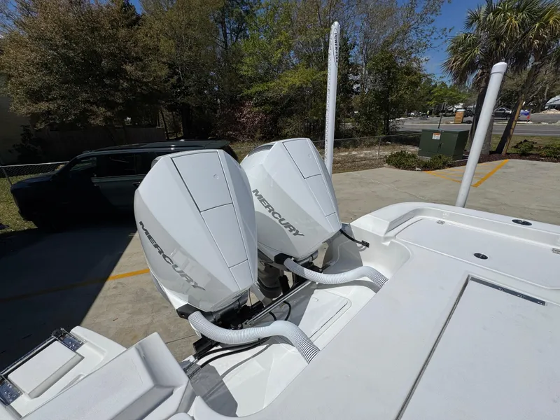 Slide: The Image of 2025 Caymas 291 boat with dual Mercury outboard engines in a parking area. - 41