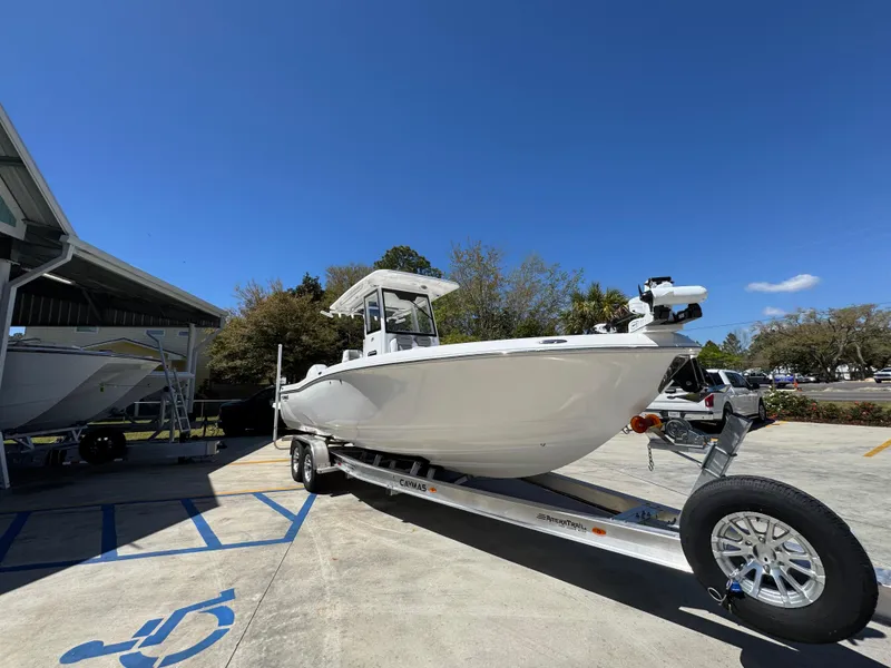 Slide: The Image of 2025 Caymas 291 boat on trailer under clear blue sky. - 8