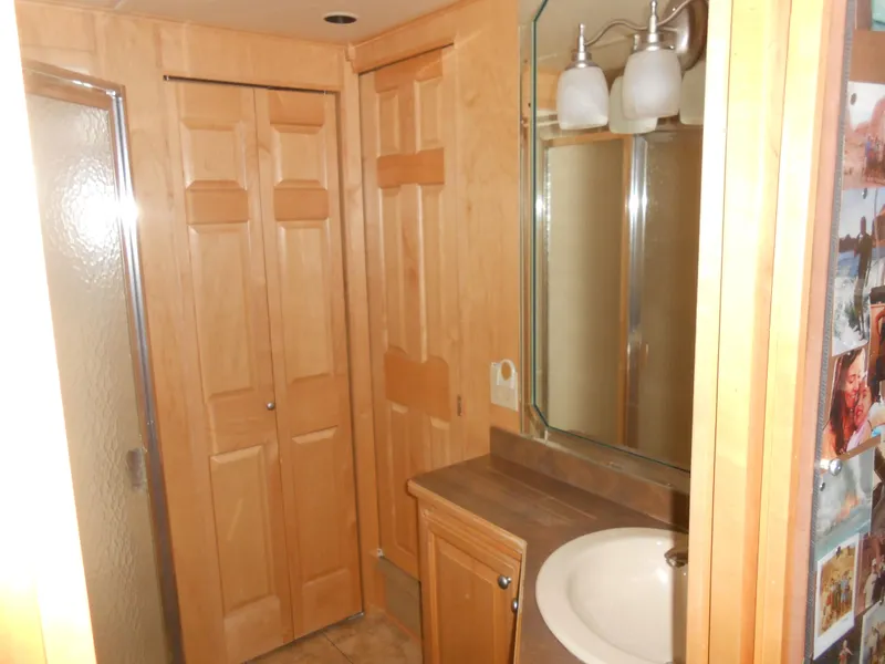 Slide: The Image of Bathroom interior of 2008 Sumerset 7518 houseboat with wooden cabinets and glass shower. - 10