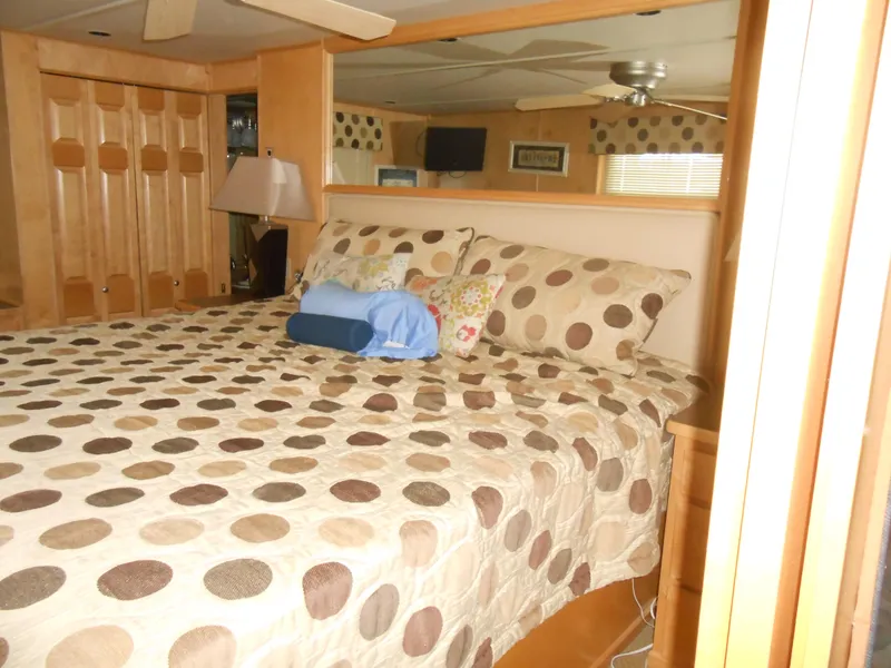 Slide: The Image of Luxurious bedroom interior in 2008 Sumerset 7518 houseboat with polka dot bedding. - 12