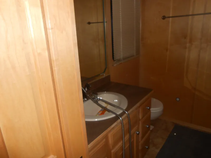 Slide: The Image of Bathroom interior of 2008 Sumerset 7518 houseboat with wooden cabinetry and sink. - 14