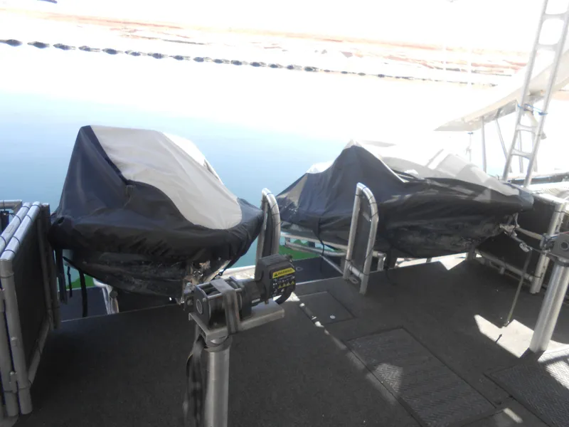 Slide: The Image of Covered equipment on a 2008 Sumerset 7518 houseboat deck by the water. - 16