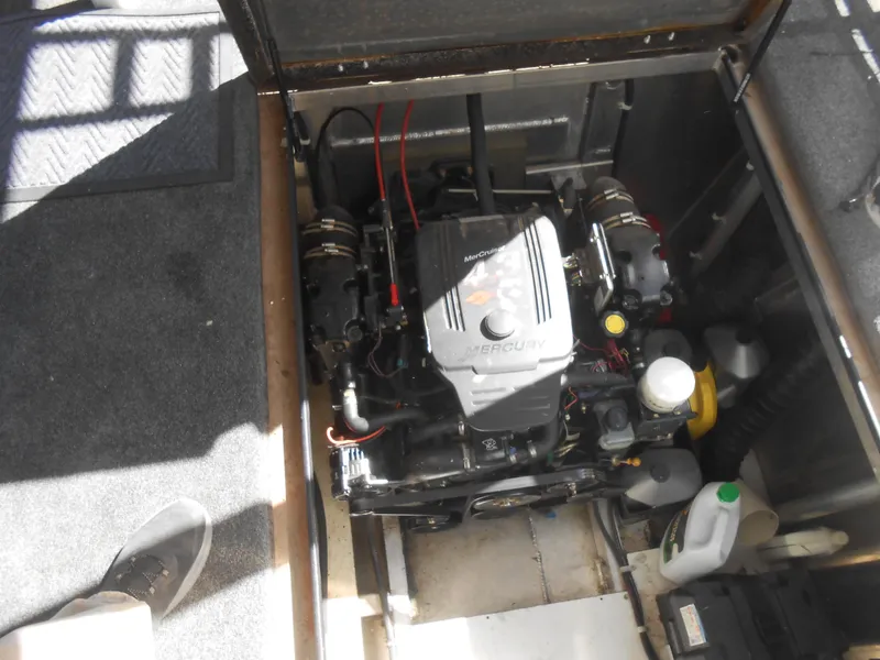 Slide: The Image of Engine compartment of a 2008 Sumerset 7518 houseboat, featuring a Mercury engine. - 17