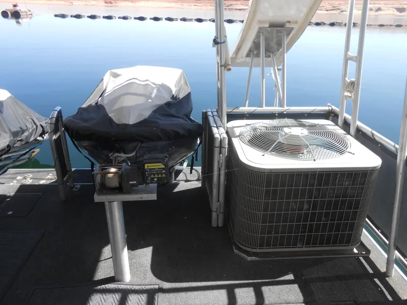 Slide: The Image of Rooftop view of a 2008 Sumerset 7518 houseboat with covered equipment and air conditioning unit. - 18