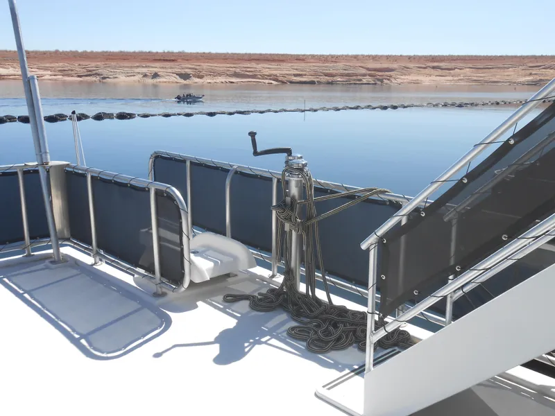 Slide: The Image of 2008 Sumerset 7518 houseboat deck with railing, stairs, and calm water view. - 21