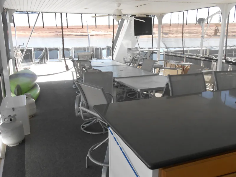 Slide: The Image of Spacious 2008 Sumerset 7518 houseboat interior with seating, tables, and outdoor view. - 26