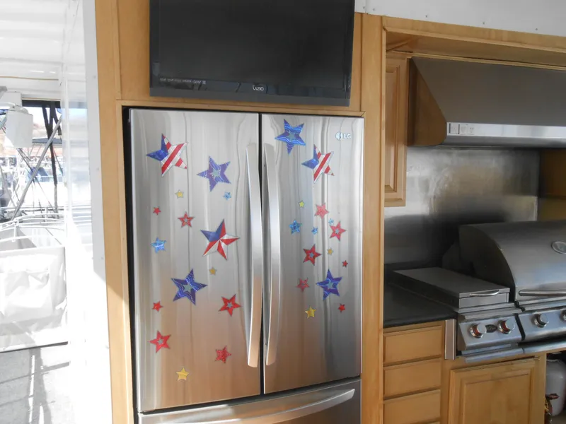 Slide: The Image of Stainless steel refrigerator with star decorations in a Sumerset 7518 houseboat kitchen, 2008 model. - 29