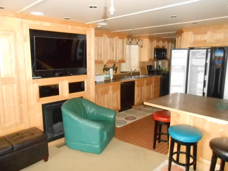 Slide: The Image of Luxurious 2008 Sumerset 7518 houseboat interior with modern kitchen and cozy living area. - 3