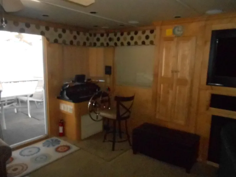 Slide: The Image of Interior of 2008 Sumerset 7518 houseboat with wooden paneling and steering wheel. - 4