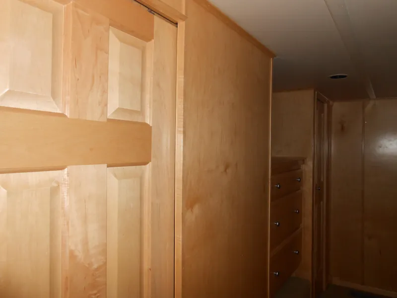 Slide: The Image of Wooden interior of a 2008 Sumerset 7518, featuring cabinets and a door. - 8