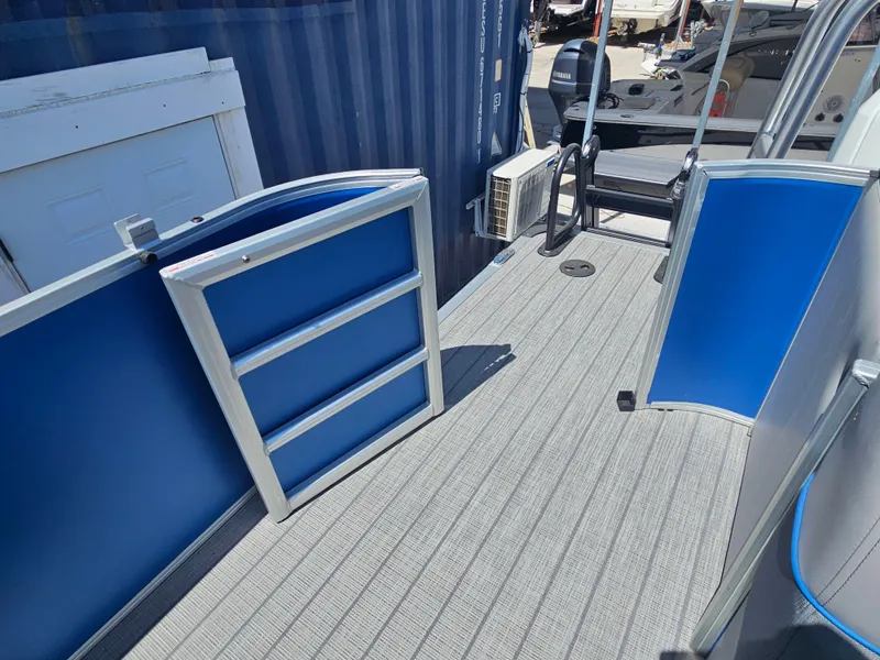 Slide: The Image of 2025 Bentley Pontoons Legacy Cruise 223 deck with blue accents and modern design. - 14