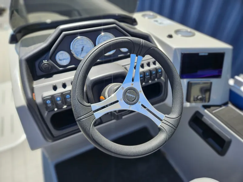 Slide: The Image of 2025 Bentley Pontoons Legacy Cruise 223 dashboard with steering wheel and control panel. - 21