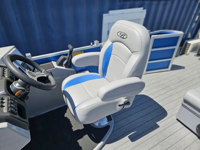 Slide: The Image of Captain's chair on 2025 Bentley Pontoons Legacy Cruise 223, featuring blue and white upholstery. - 22