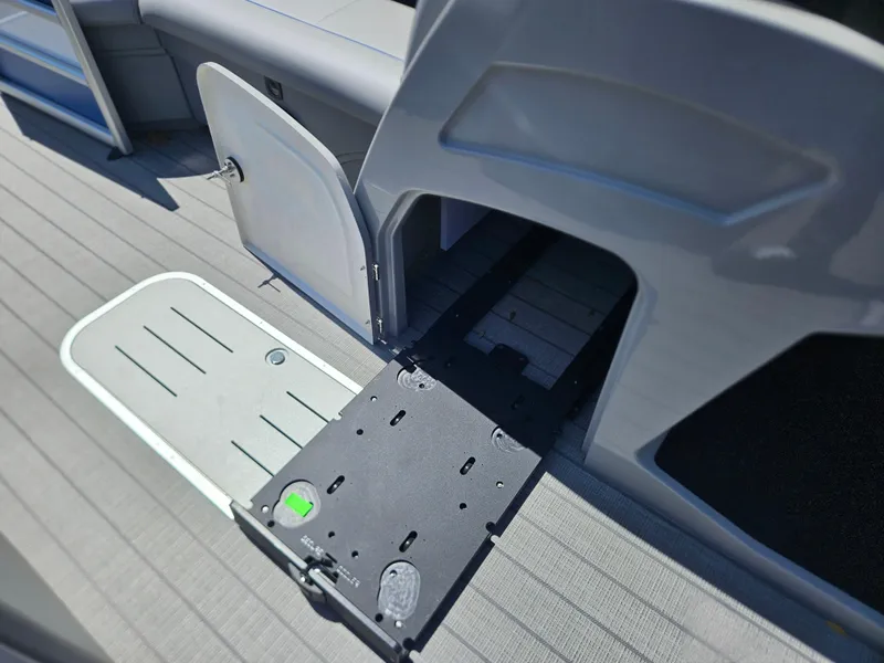 Slide: The Image of 2025 Bentley Pontoons Legacy Cruise 223 interior with open storage compartment and deck view. - 23