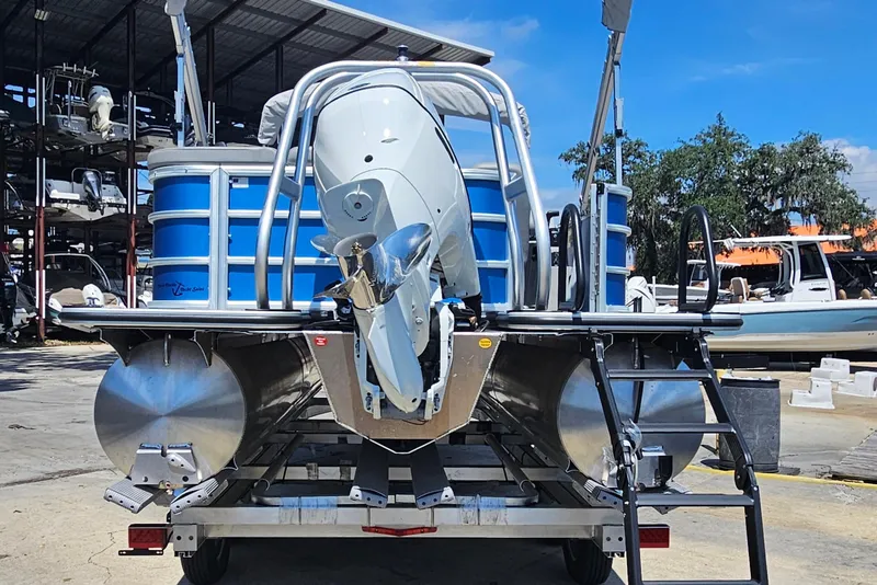 Slide: The Image of 2025 Bentley Pontoons Legacy Cruise 223 on trailer, showcasing rear view and motor. - 6