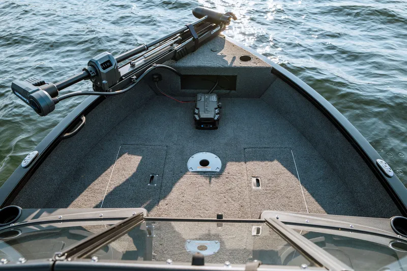 Slide: The Image of 2025 Crestliner 1650 Hawk SC J boat deck on water, featuring fishing equipment. - 4