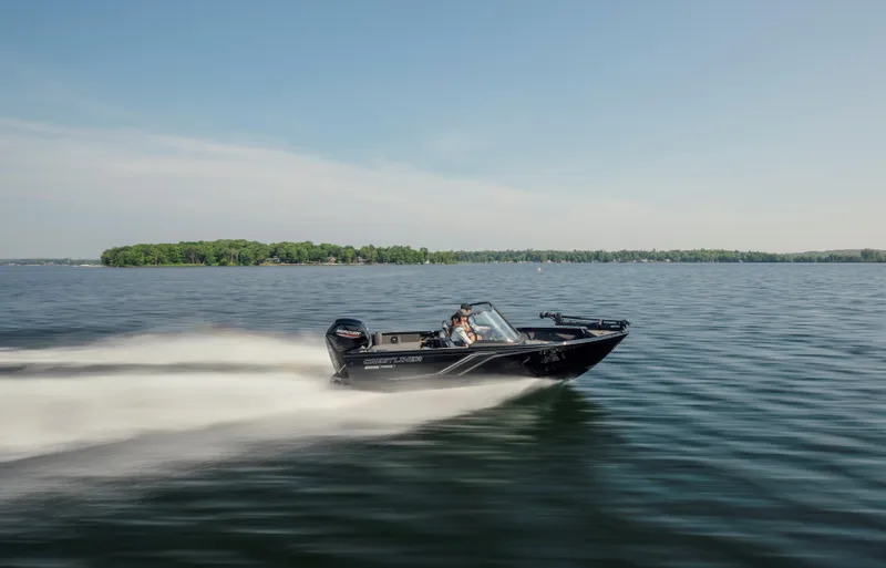 Slide: The Image of 2025 Crestliner 1650 Hawk SC J speeding on a lake under clear skies. - 5