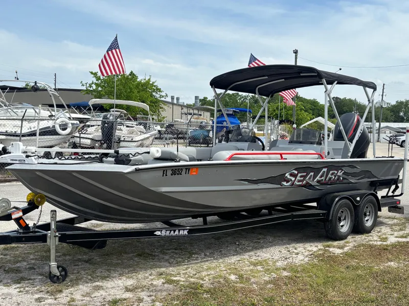 Slide: The Image of 2019 SeaArk Big Easy boat on trailer with canopy, parked outdoors. - 0