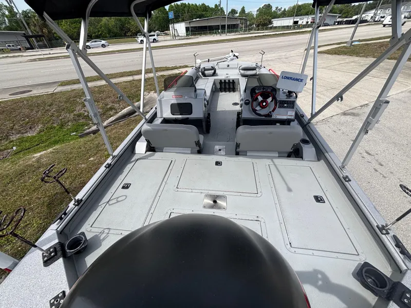 Slide: The Image of 2019 SeaArk Big Easy boat interior with seating, steering console, and fishing equipment. - 10