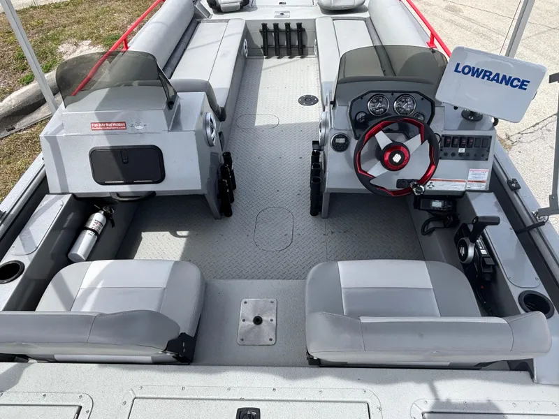 Slide: The Image of 2019 SeaArk Big Easy boat interior with steering console and seating. - 11