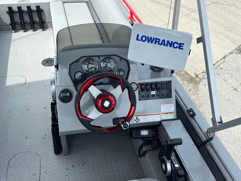 Slide: The Image of 2019 SeaArk Big Easy boat dashboard with Lowrance system and red steering wheel. - 12