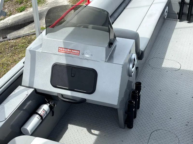 Slide: The Image of 2019 SeaArk Big Easy boat interior with rod holder and fire extinguisher. - 13