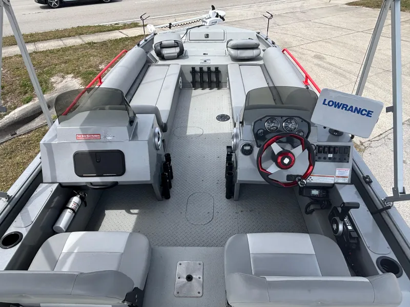 Slide: The Image of 2019 SeaArk Big Easy boat interior with seating, steering wheel, and Lowrance equipment. - 14