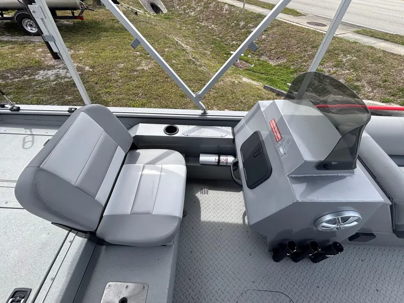 Slide: The Image of 2019 SeaArk Big Easy boat interior with gray seating and control console. - 15