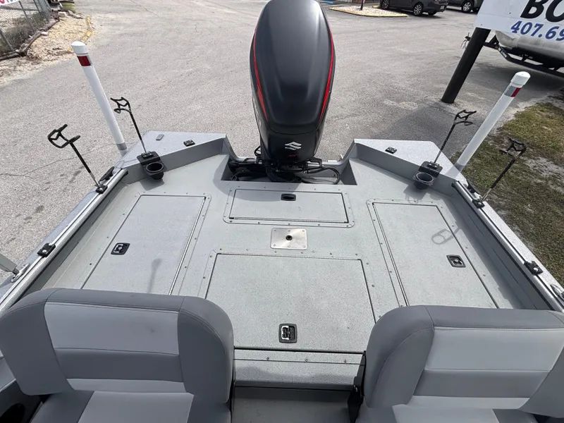 Slide: The Image of 2019 SeaArk Big Easy boat deck with motor and seating area. - 16