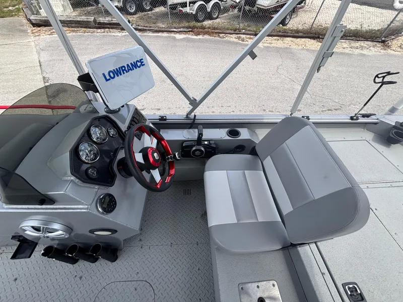 Slide: The Image of 2019 SeaArk Big Easy boat interior with steering wheel, gauges, and Lowrance navigation system. - 17