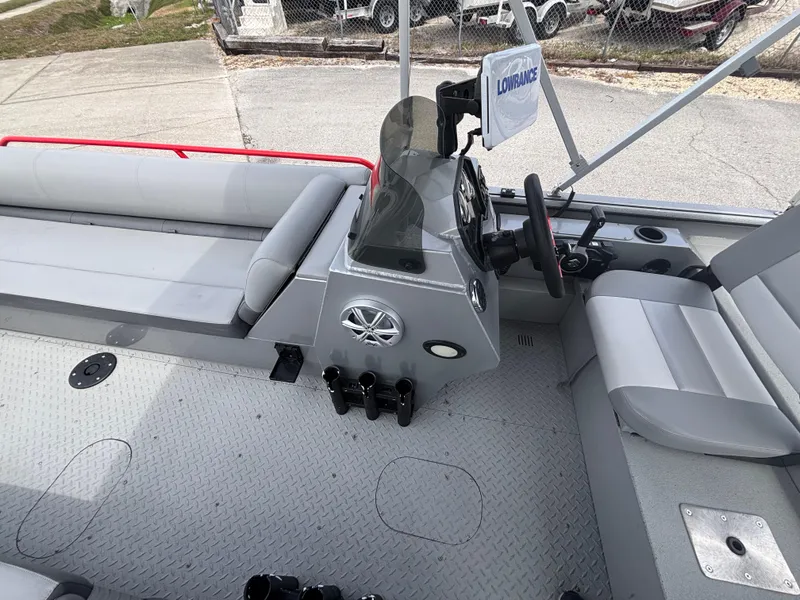 Slide: The Image of 2019 SeaArk Big Easy boat interior with seating and steering console. - 18
