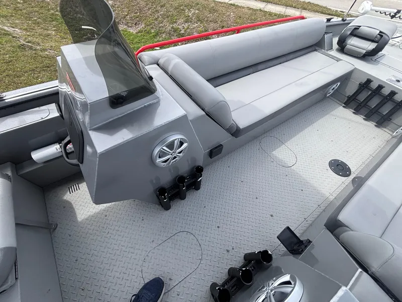 Slide: The Image of 2019 SeaArk Big Easy boat interior with gray seating and steering console. - 19