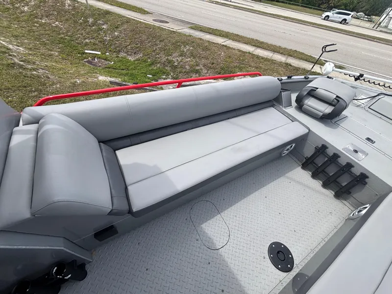 Slide: The Image of 2019 SeaArk Big Easy boat with gray seating and red railing, viewed from above. - 20