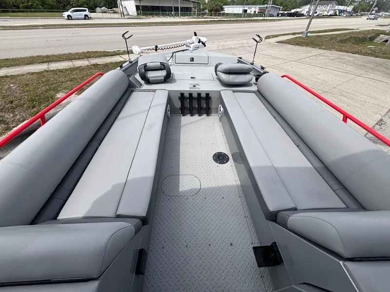 Slide: The Image of 2019 SeaArk Big Easy boat interior with gray seating and red railings. - 22