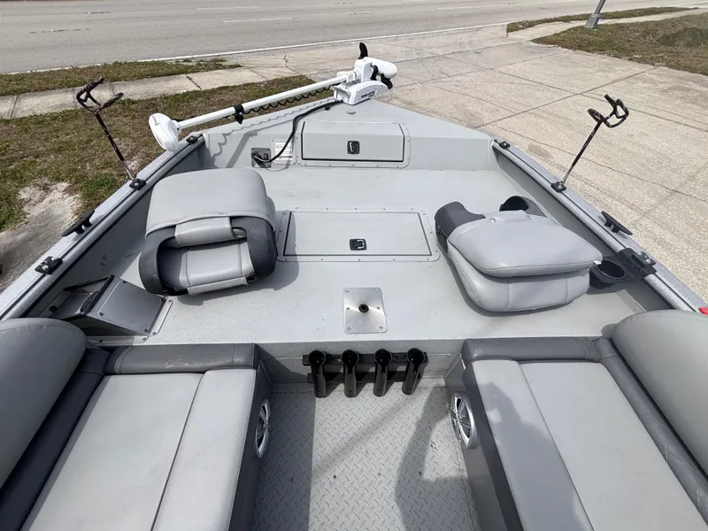 Slide: The Image of 2019 SeaArk Big Easy boat interior with seating and fishing rod holders. - 23
