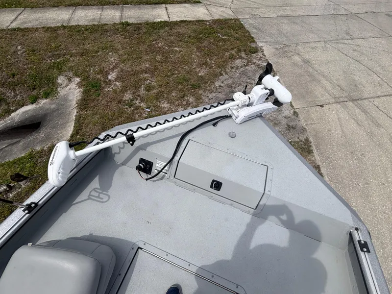 Slide: The Image of 2019 SeaArk Big Easy boat deck with trolling motor and storage compartment. - 24