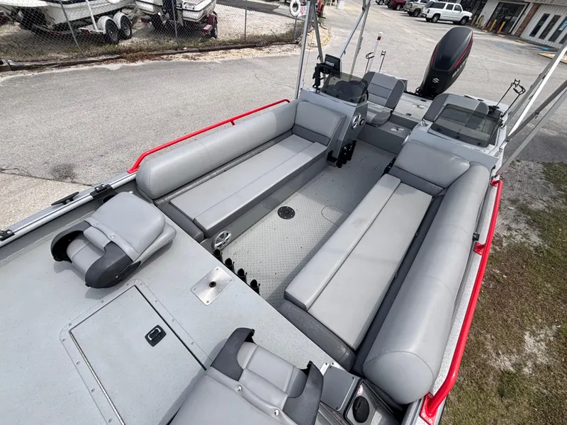 Slide: The Image of 2019 SeaArk Big Easy boat interior with gray seating and red accents. - 28