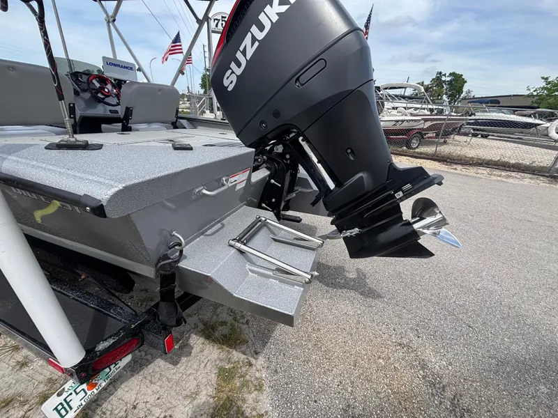 Slide: The Image of 2019 SeaArk Big Easy boat with Suzuki outboard motor, parked on a trailer. - 32