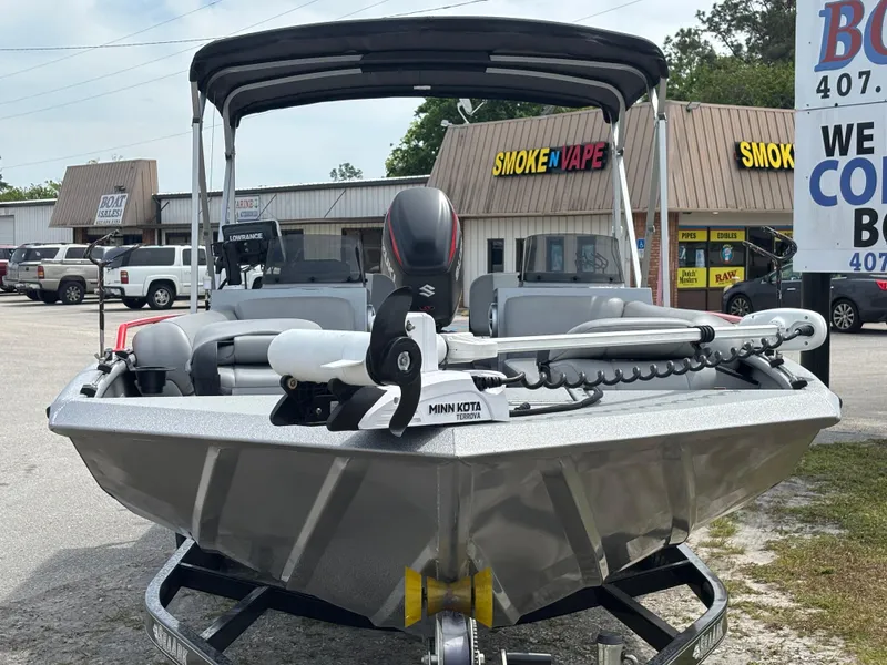 Slide: The Image of 2019 SeaArk Big Easy boat with Minn Kota motor, parked in front of shops. - 4