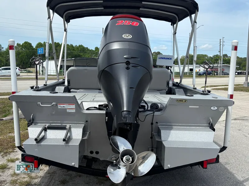 Slide: The Image of 2019 SeaArk Big Easy boat with powerful 250 HP outboard motor, parked outdoors. - 7