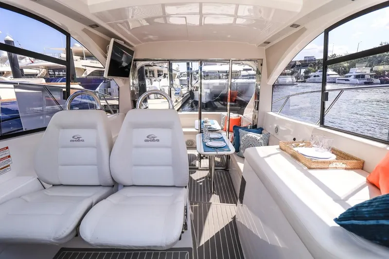Slide: The Image of Luxurious interior of 2021 Evolve 400HT yacht with plush seating and elegant dining setup. - 11