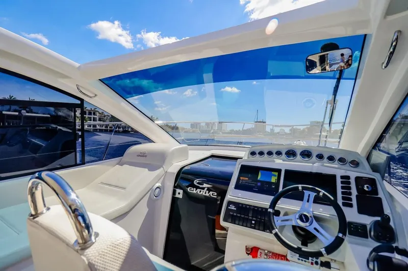 Slide: The Image of Interior view of 2021 Evolve 400HT yacht cockpit with modern controls and steering wheel. - 12