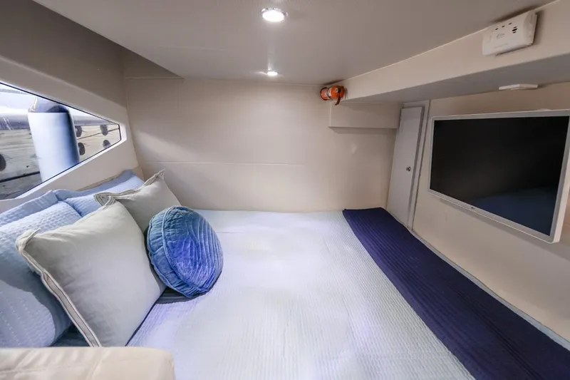 Slide: The Image of Luxurious interior cabin of 2021 Evolve 400HT yacht with cozy bedding and modern TV. - 14