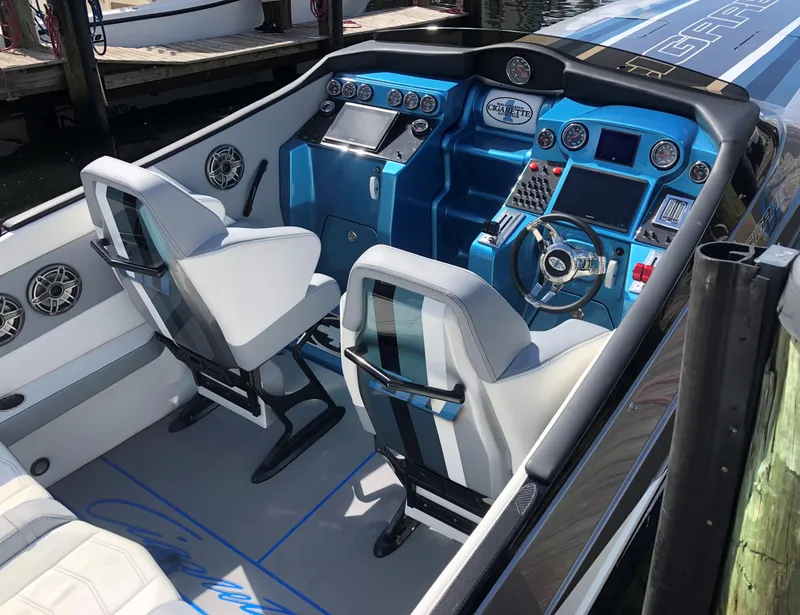 Slide: The Image of 2011 Cigarette 50 boat cockpit with blue dashboard, modern controls, and white seating. - 3