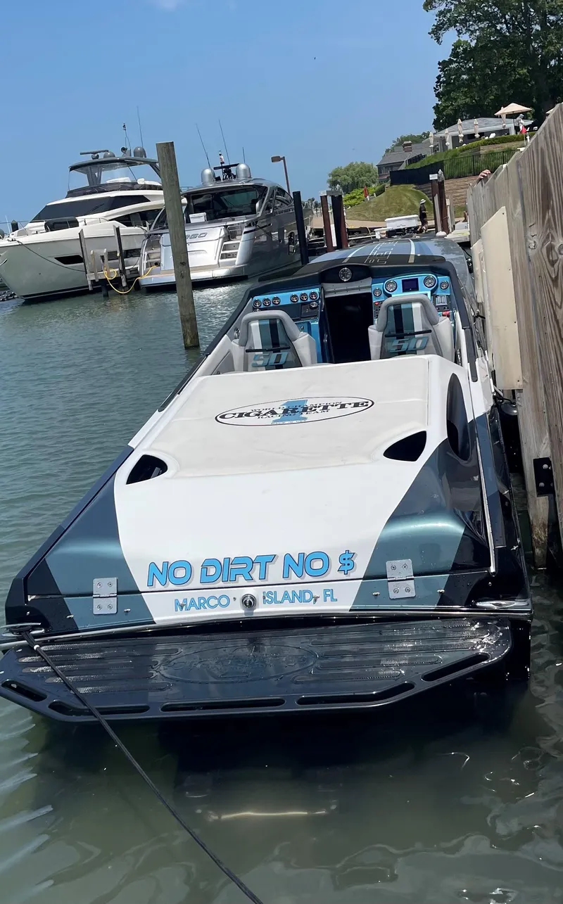 Slide: The Image of 2011 Cigarette 50 boat docked at Marco Island, Florida, with "No Dirt No $" text. - 4